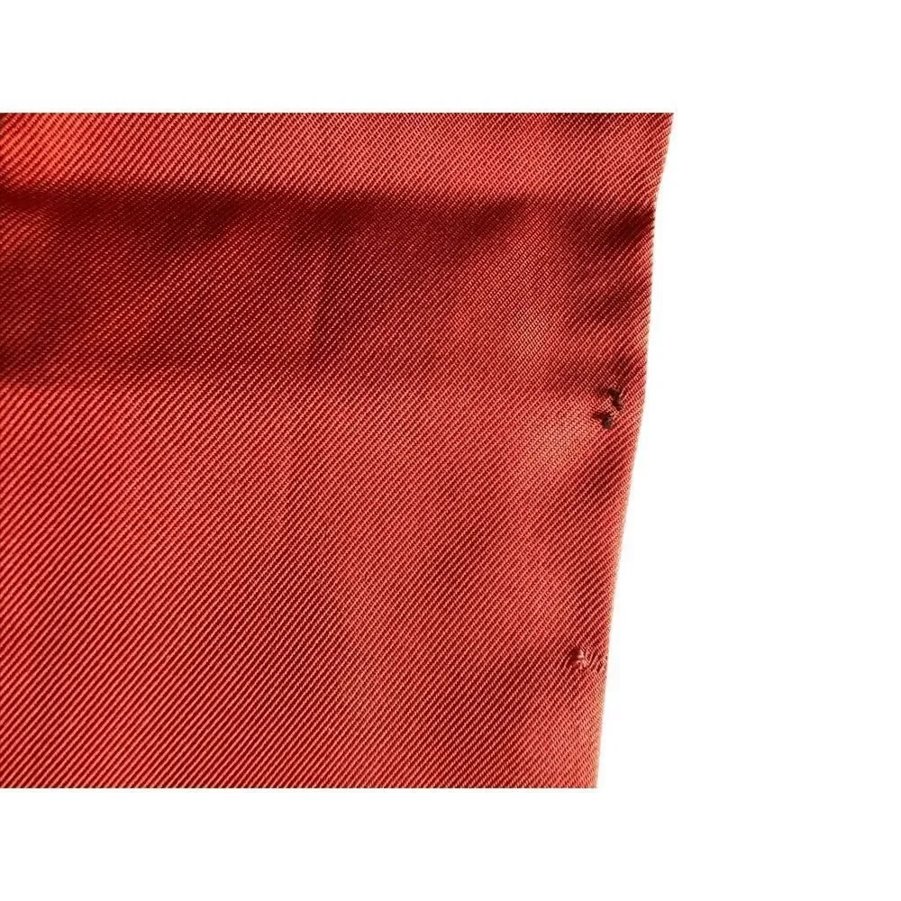 COACH silk twilly scarf orange poppy and tan signature Cs background